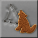 Decorated coyote shaped cookie next to a  3 inch Coyote Metal Cookie Cutter