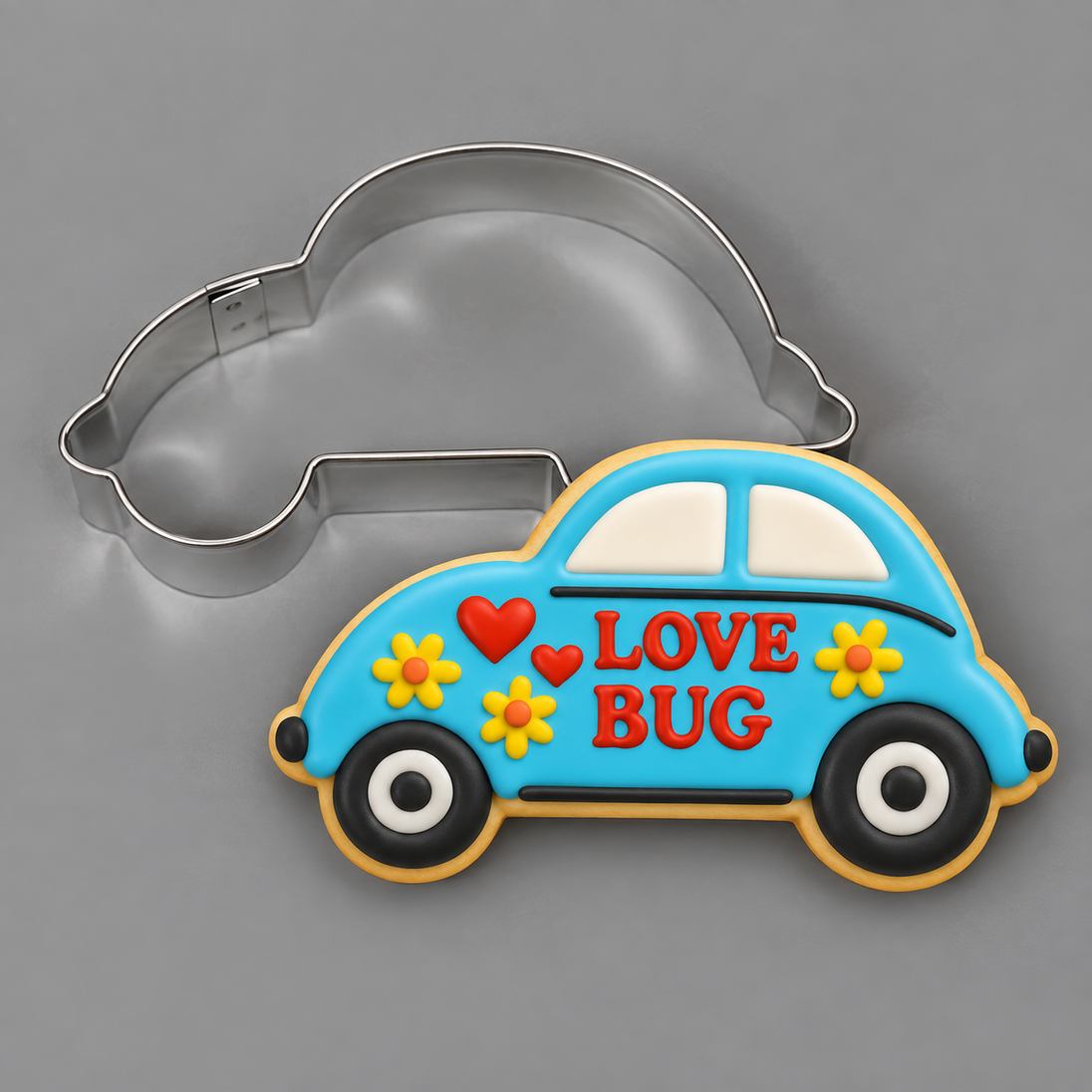 Compact car decorated cookie with LOVE BUG written on it next to a 3.5 inch Compact Car Metal Cookie Cutter
