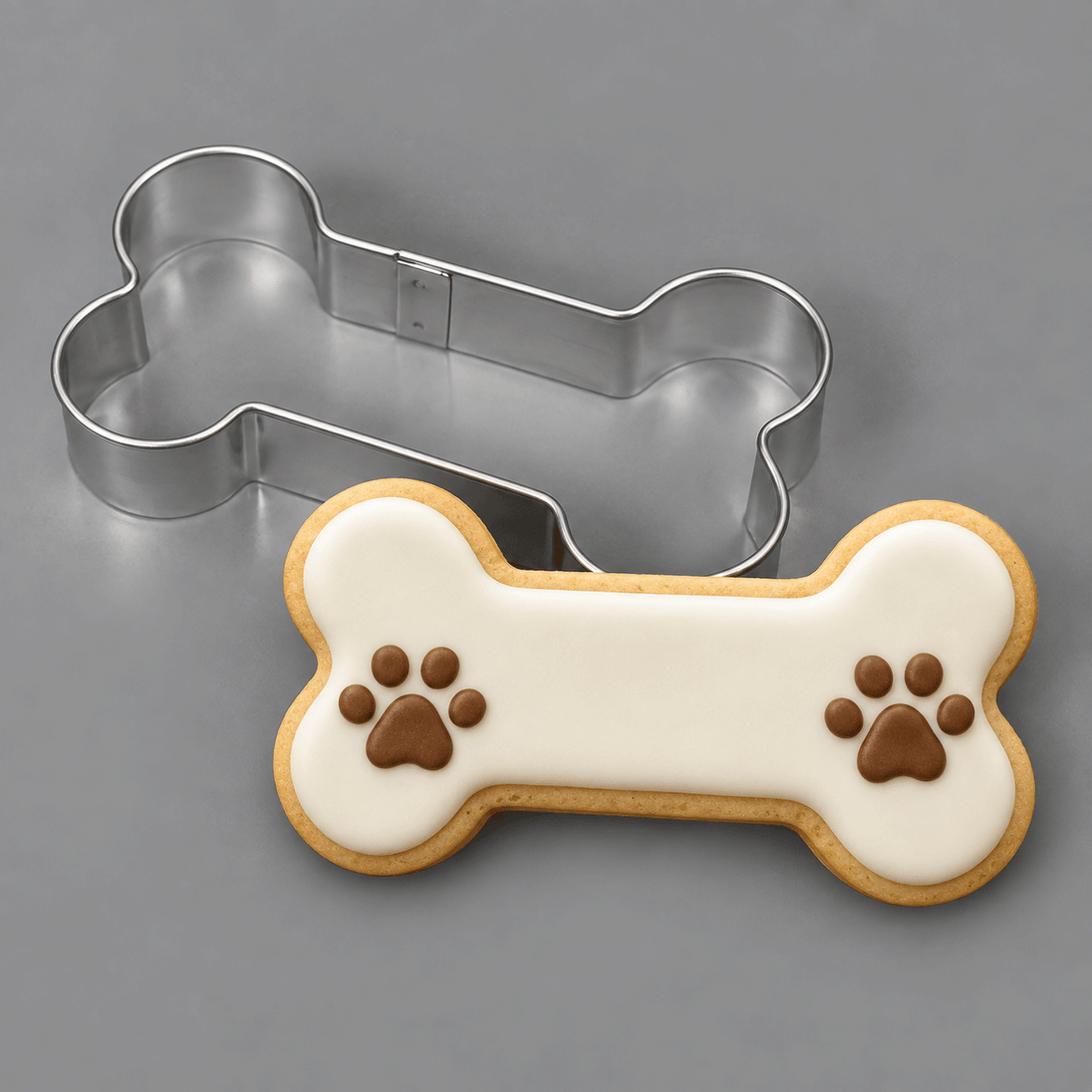 Dog bone cookie decorated with paws and a 4.5 inch Dog Bone Metal Cookie Cutter