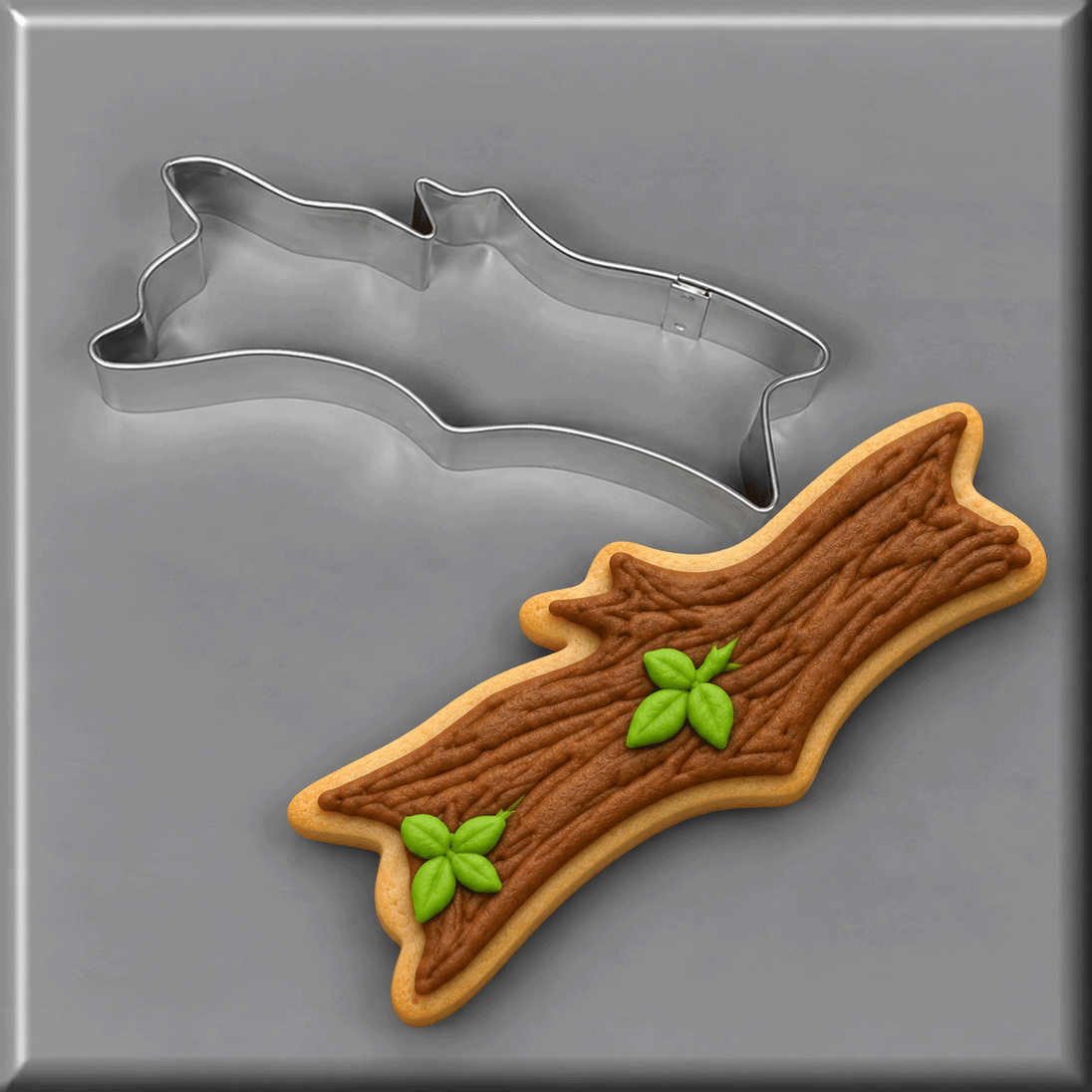 Stick or log cookie next to a 5 inch Camping Log Stick Metal Cookie Cutter
