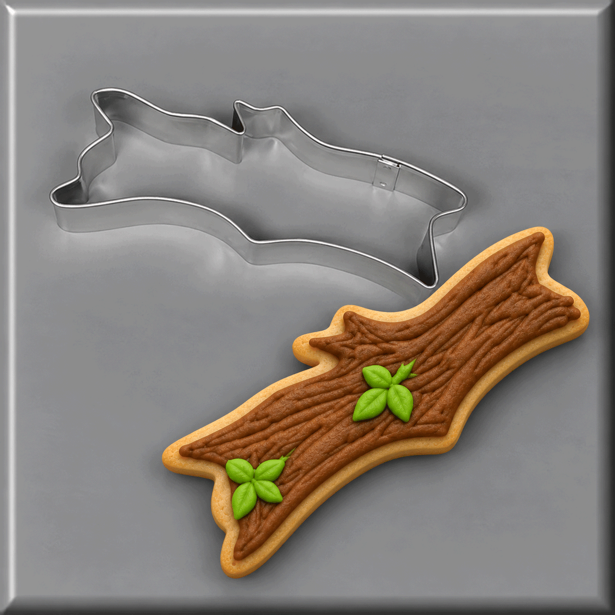 Stick or log cookie next to a 5 inch Camping Log Stick Metal Cookie Cutter