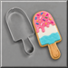 A Popsicle shaped cookie next to a 4.5 inch Popsicle Metal Cookie Cutter
