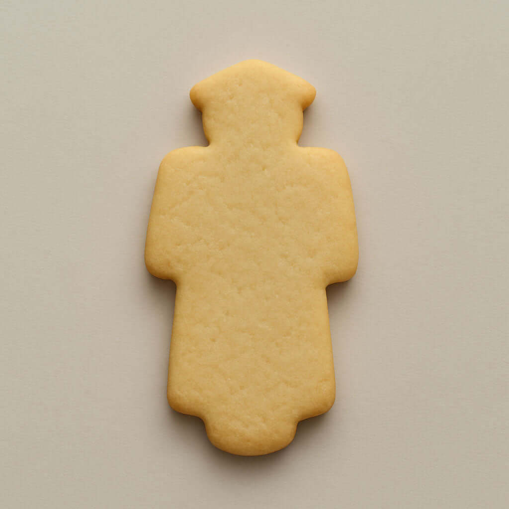 4.75 inch Graduation Graduate Metal Cookie Cutter shaped cookie on a neutral background.