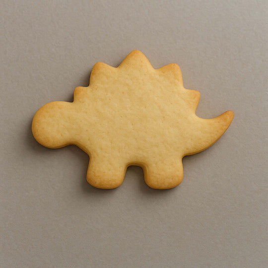 Plain stegosaurus-shaped cookie on a gray background from a 4 inch Stegosaurus Metal Cookie Cutter